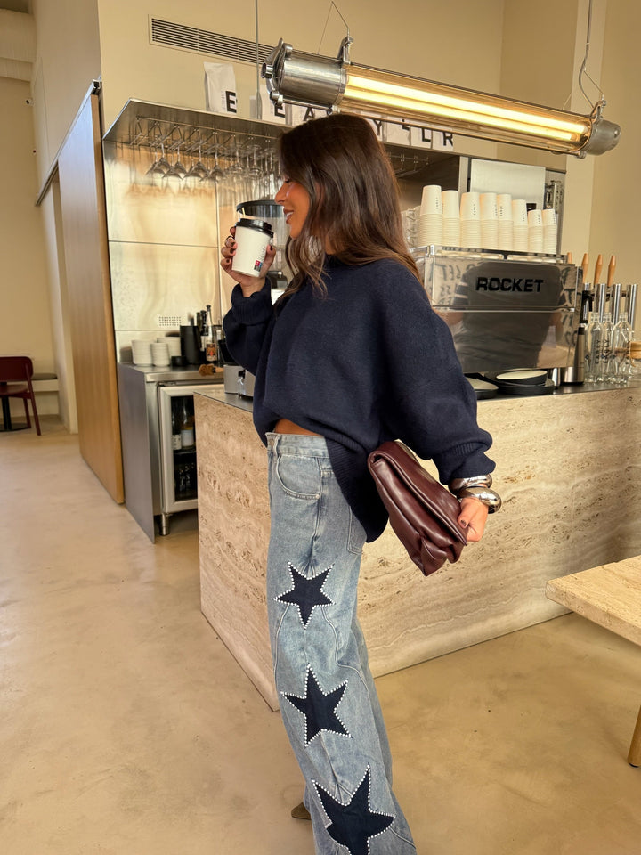 Calças de denim com estrela preta